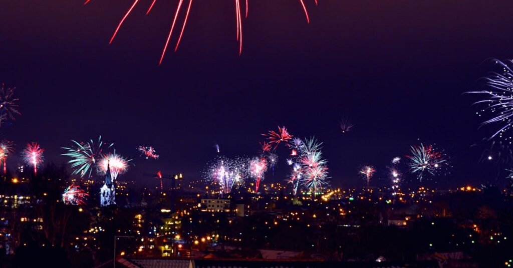 Vibrant fireworks light up the night sky over a city. Perfect for celebrations or festive events.
